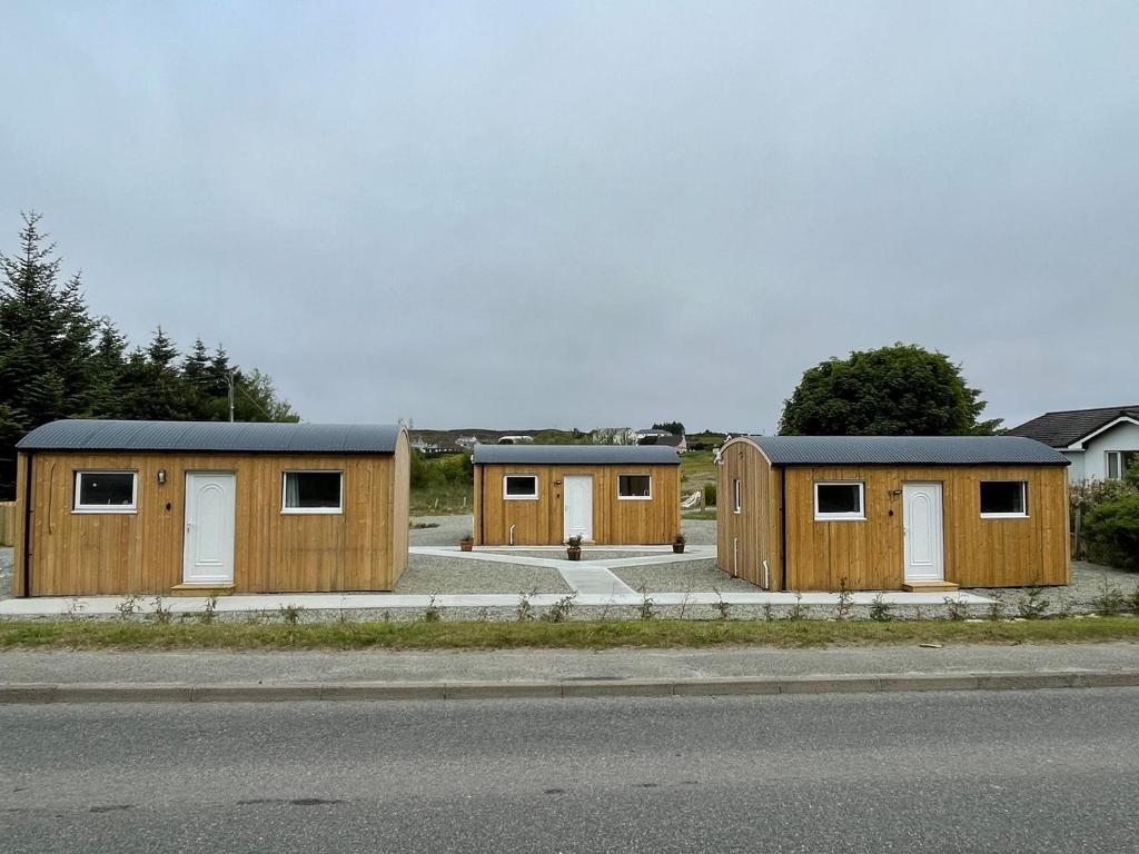 a row of wooden buildings on the side of the road at Harris - Uk34048 in Stornoway