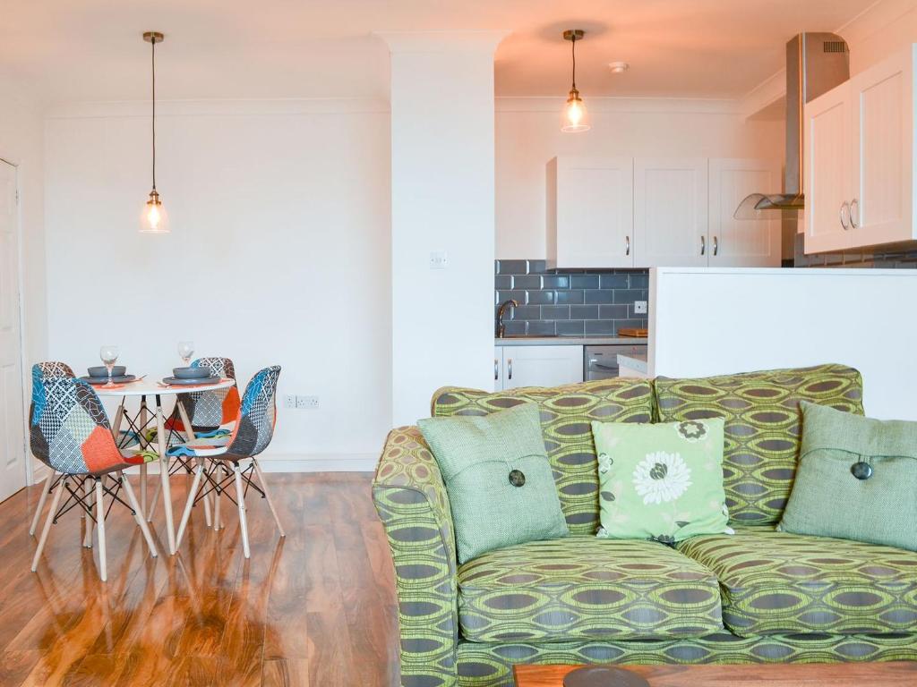 a living room with a couch and a kitchen at Duncan Square in Whitehaven