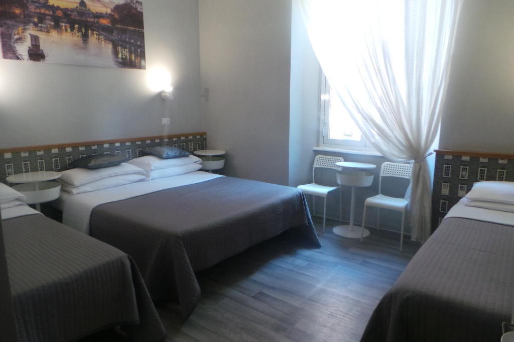 Postel nebo postele na pokoji v ubytování Hotel Castelfidardo