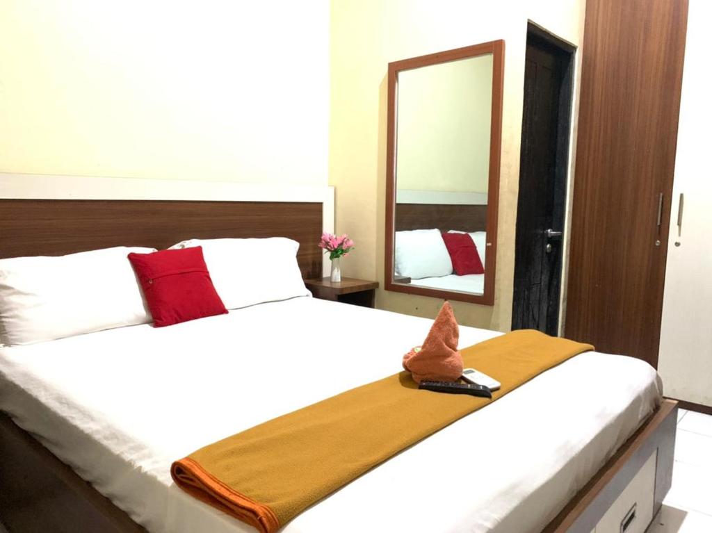 Ένα ή περισσότερα κρεβάτια σε δωμάτιο στο HOMESTAY AKAVI JAYAPURA
