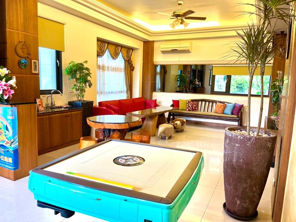 a living room with a couch and a table at Weiden House in Luodong