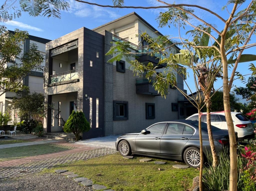 a car parked in front of a house at Weiden House in Luodong