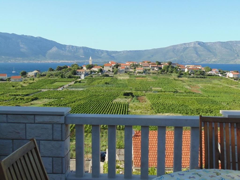 a balcony with a view of a vineyard at VILLA Apartments Mate Cebalo in Lumbarda