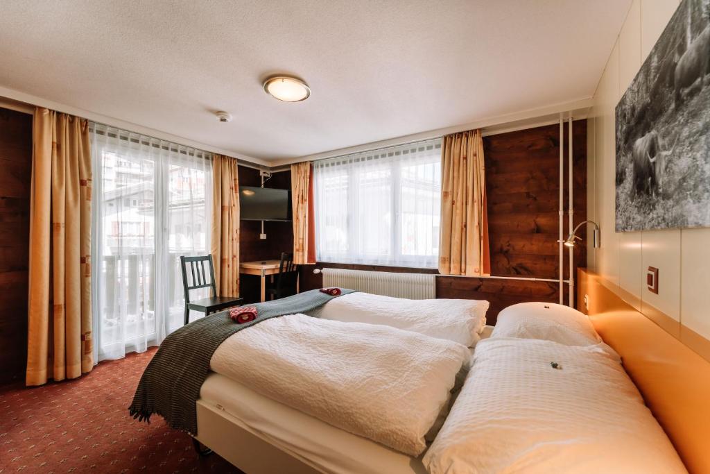 Postel nebo postele na pokoji v ubytování Hotel Les Amis