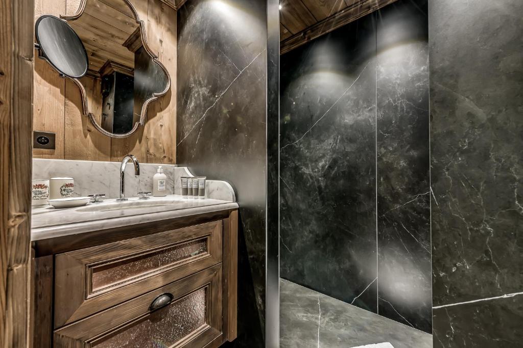 a bathroom with a shower and a sink at HOTEL LE VAL D&#39;ISERE in Val-d&#39;Isère