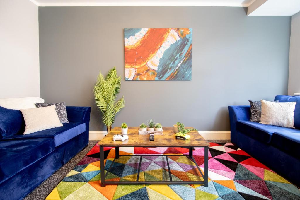 Sala de estar con sofá azul y mesa de centro en Stunning House Free Parking Garden WiFi en Bristol