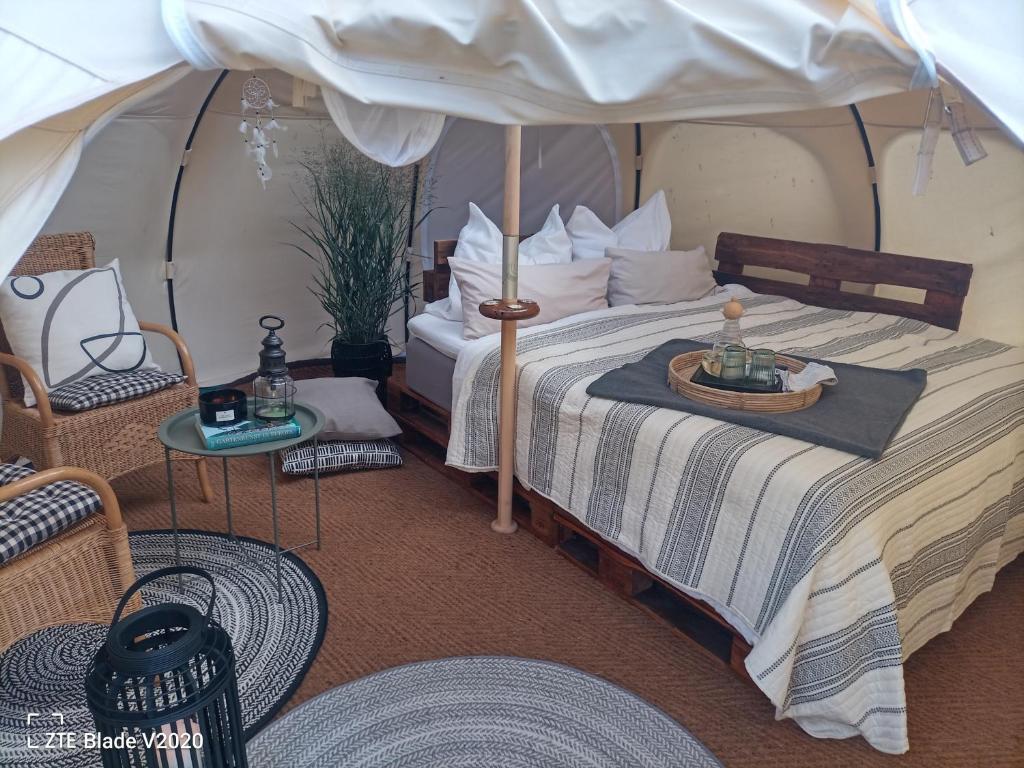 a bedroom with a bed in a tent at Glamping Altes Pastorat in Barmstedt