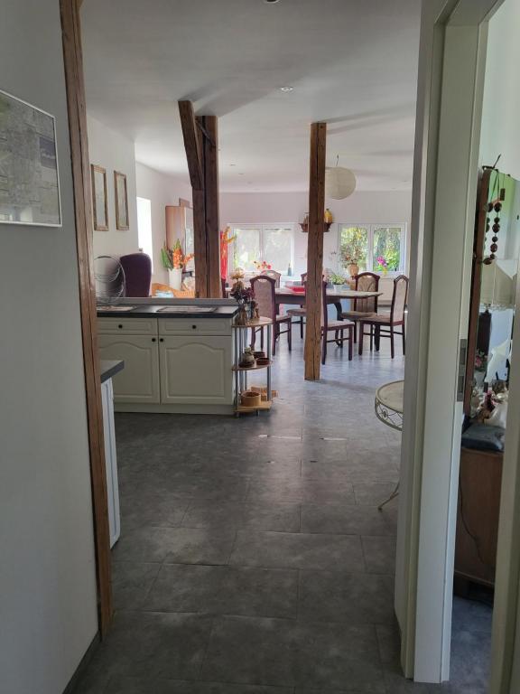 a kitchen and living room with a table and chairs at Ferienwohnung Markranstädt in Markranstädt