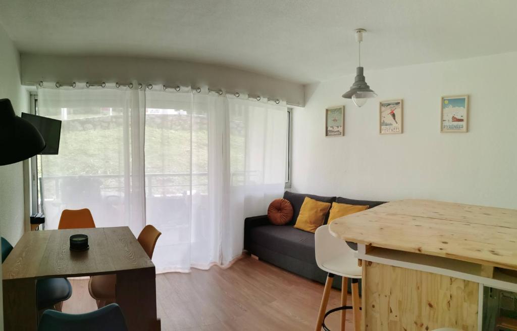 a living room with a couch and a table at Gourette studio près des pistes, Résidence Val Soleil, 256 Gourette Nord, rue de Tortes in Gourette
