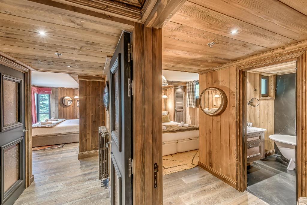 a bathroom with wooden walls and wooden flooring at HOTEL LE VAL D&#39;ISERE in Val-d&#39;Isère