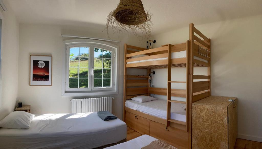 a bedroom with two bunk beds and a window at Amama Baita in Urrugne