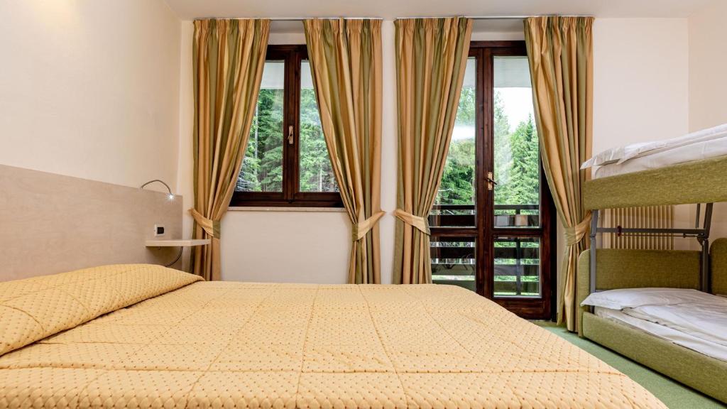 Postel nebo postele na pokoji v ubytování Hotel Alaska