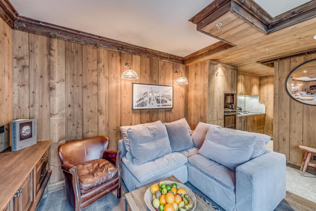a living room with a couch and a table at Hotel & Spa Le Val d'Isère in Val-d'Isère