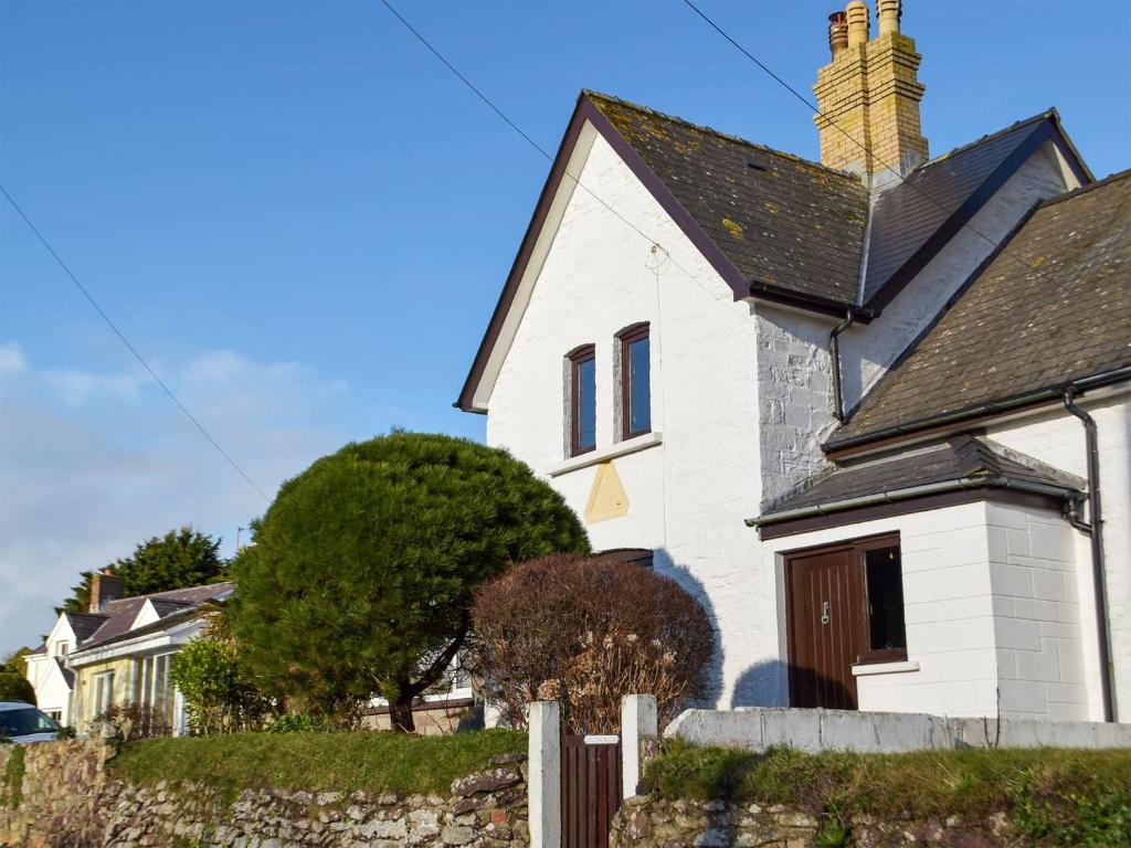 a white house with a black roof at Collingwood in Marloes