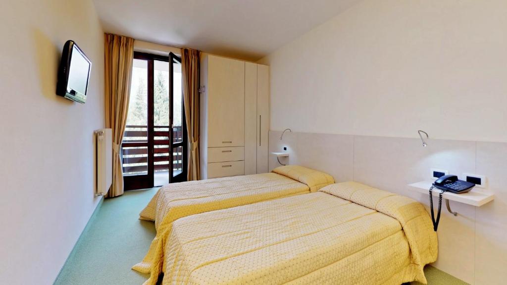 Postel nebo postele na pokoji v ubytování Hotel Alaska
