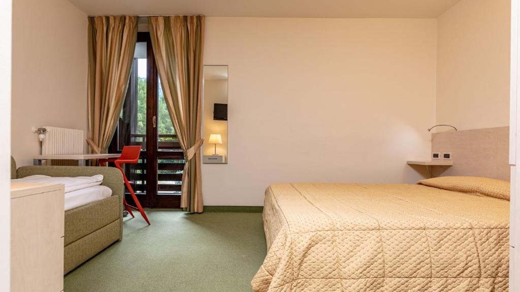 Postel nebo postele na pokoji v ubytování Hotel Alaska