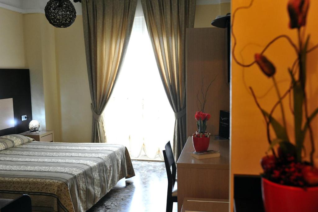 A bed or beds in a room at Hotel Gabbiano