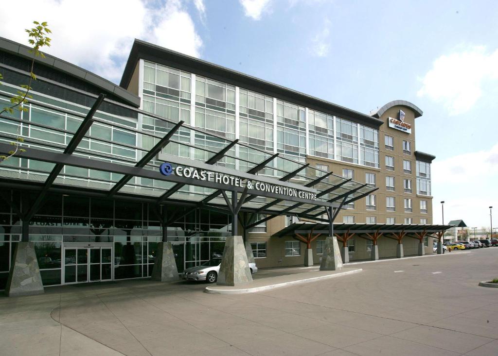 a large building with a car parked in front of it at Coast Hotel & Convention Centre in Langley
