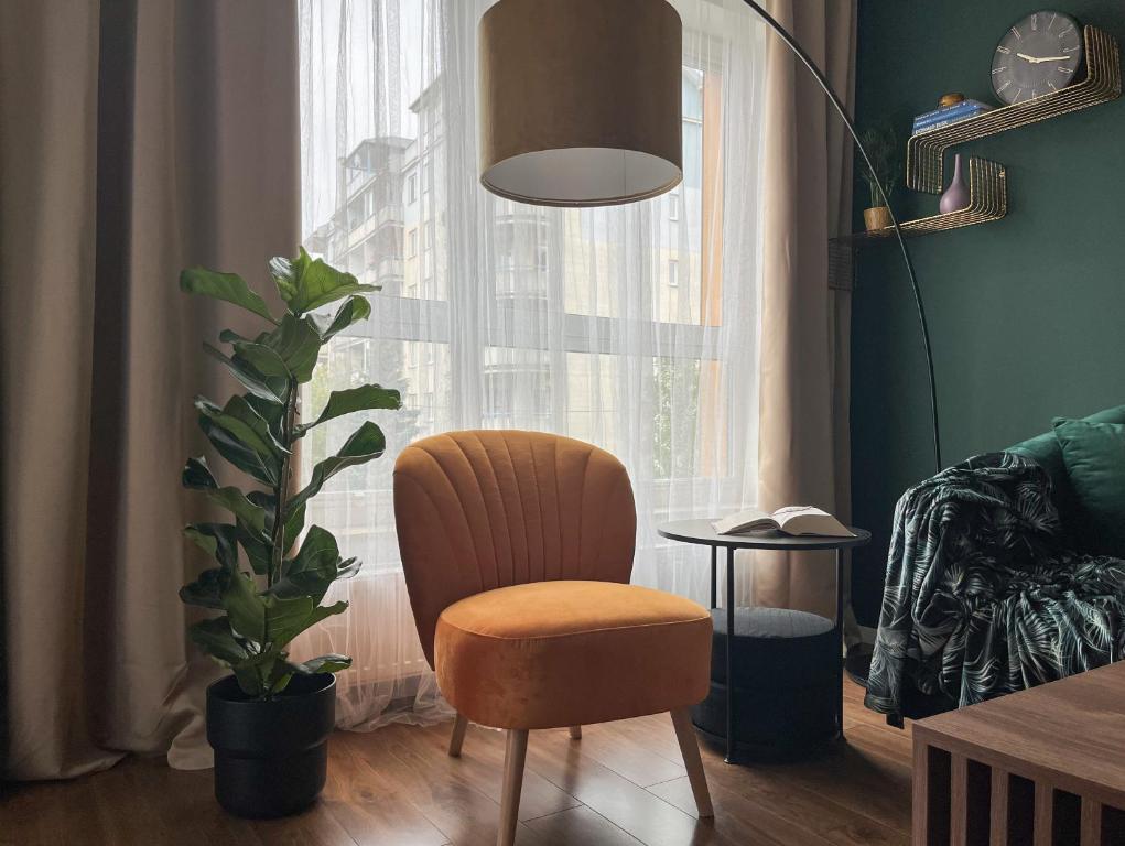 a living room with a chair and a window at Elegant and comfortable apartment Warsaw in Warsaw