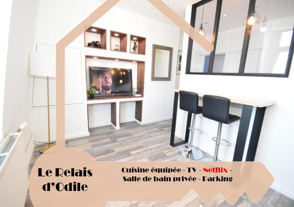 uma sala de estar com uma televisão e uma mesa em DESIGN APPART - HYPER CENTRE - TRAM - FREE WIFI - leRelaisdOdile21 em Valenciennes