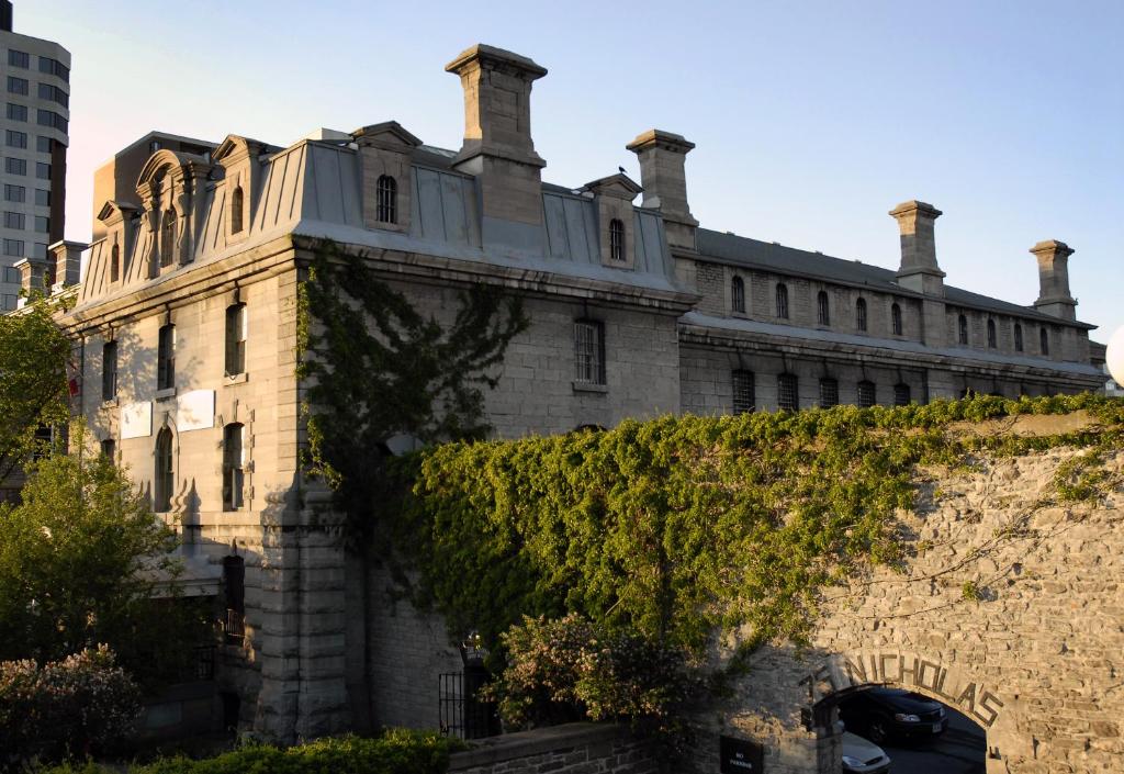 un antiguo edificio de piedra con hiedra en una pared en Saintlo Ottawa Jail Hostel, en Ottawa