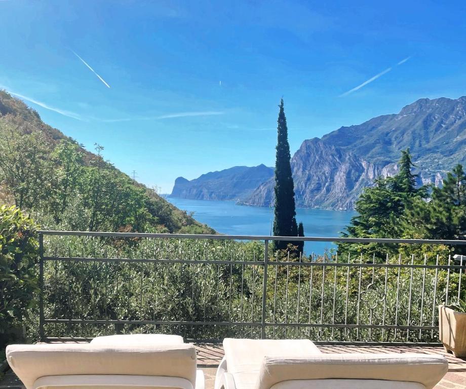 a balcony with a view of a lake and mountains at ViewLake Apartment in Nago-Torbole