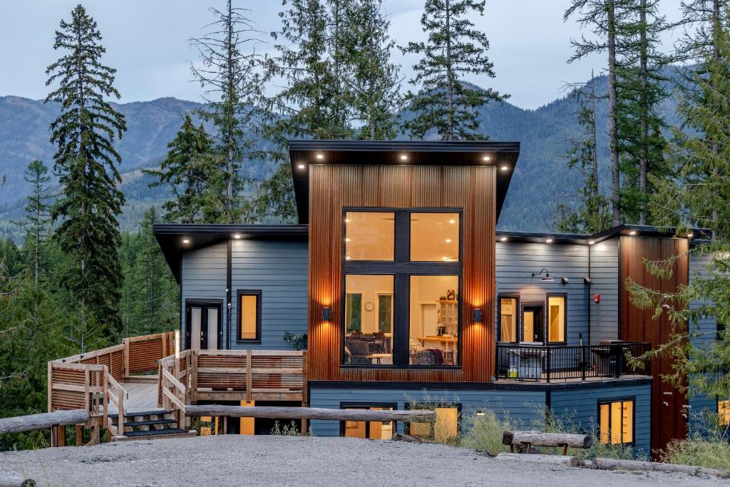 a modern house with a view of the mountains at The Qanuk Fernie - Ski In Ski Out in Fernie