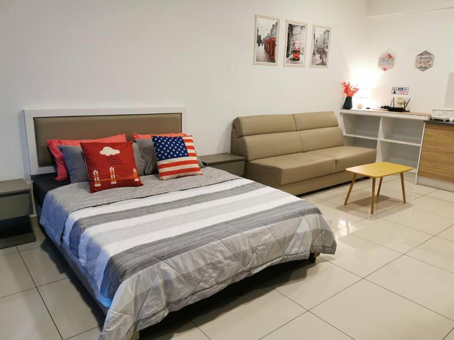a bedroom with a large bed and a couch at G Studio Swimming Pool View@EVO BANGI NETFLIX+WIFI in Kampong Sungai Ramal Dalam