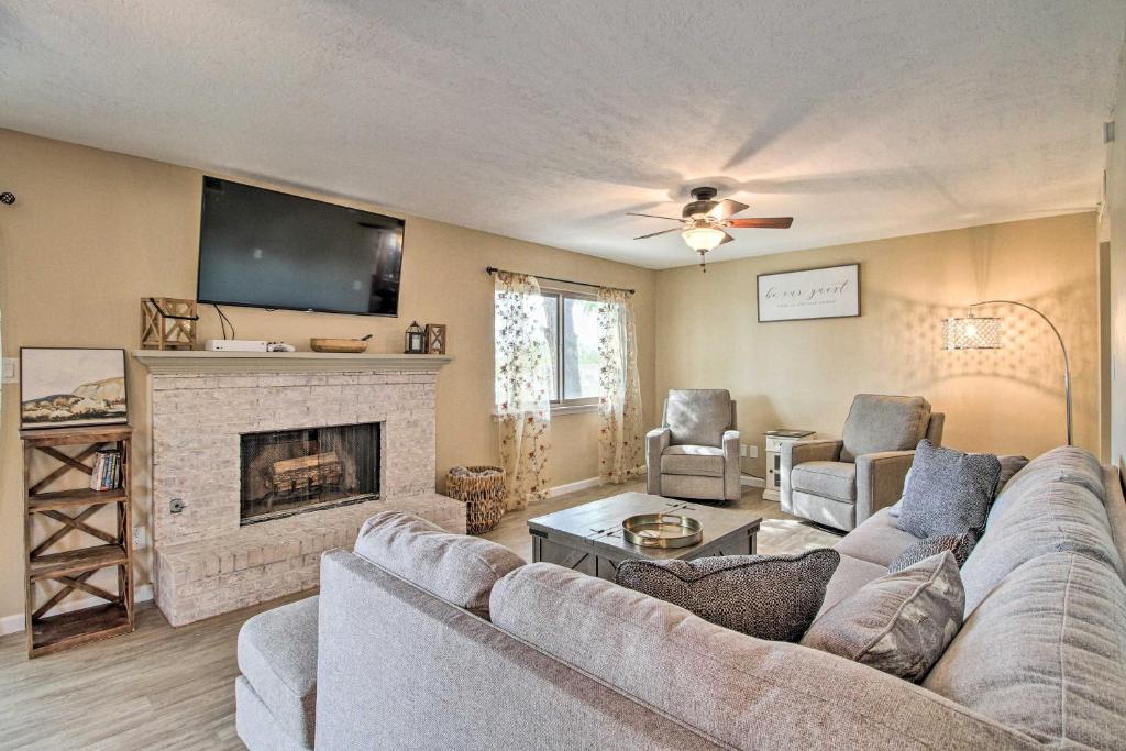 a living room with a couch and a fireplace at Updated Albuquerque Home with Backyard and Grill! in Albuquerque