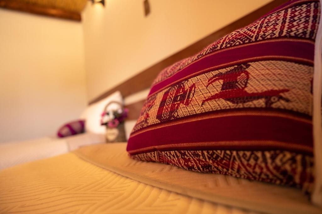 Postel nebo postele na pokoji v ubytování Lodge El Portal de Qopuy