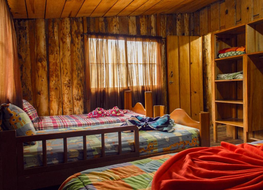 a bedroom with two bunk beds and a window at Alla Arriba in Las Cruces