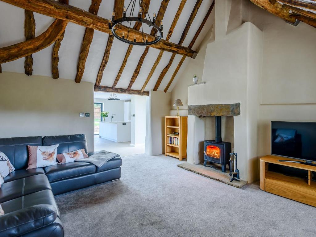 a living room with a couch and a fireplace at The Restored Cottage in Eccleston
