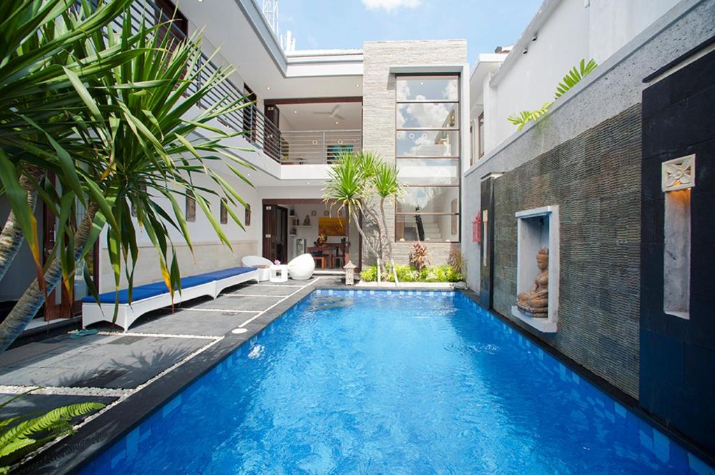 a swimming pool in the backyard of a house at Villa Penelopy in Seminyak