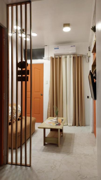 a living room with a table and a bed at Manila 1BR Cozy Homestay near UST/San Lazaro in Manila