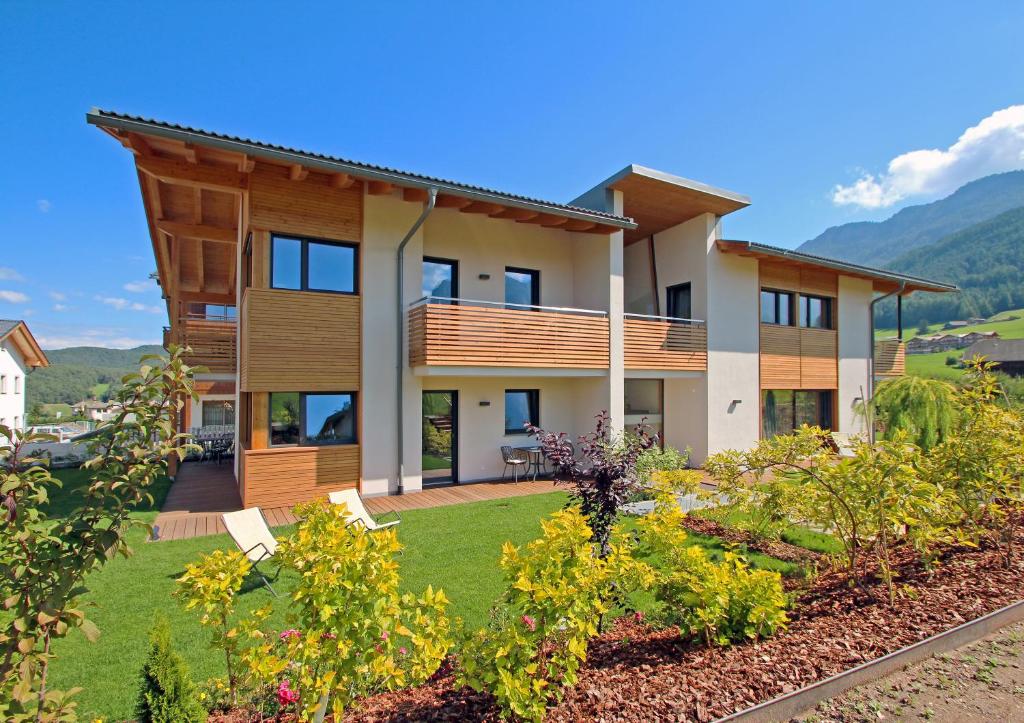 a house with a garden in front of it at Apartments Cornelia in Castelrotto