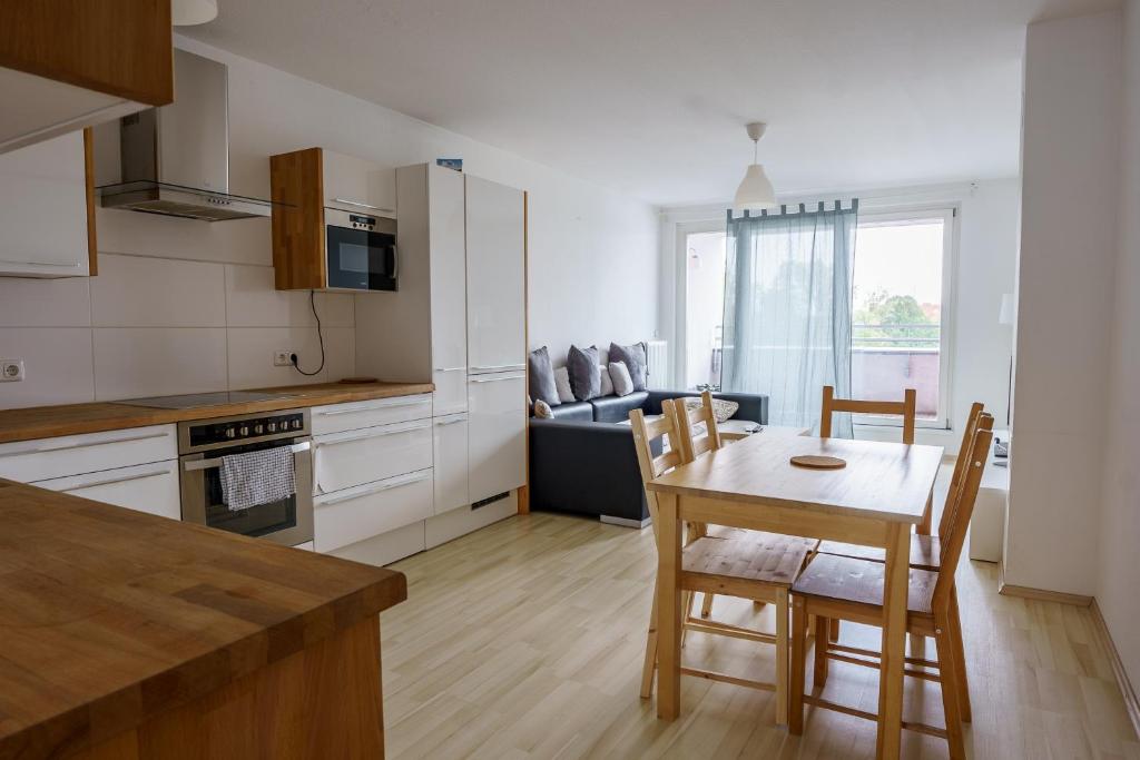 a kitchen and dining room with a table and chairs at Vienna City Apartment 1230 Vienna in Vienna