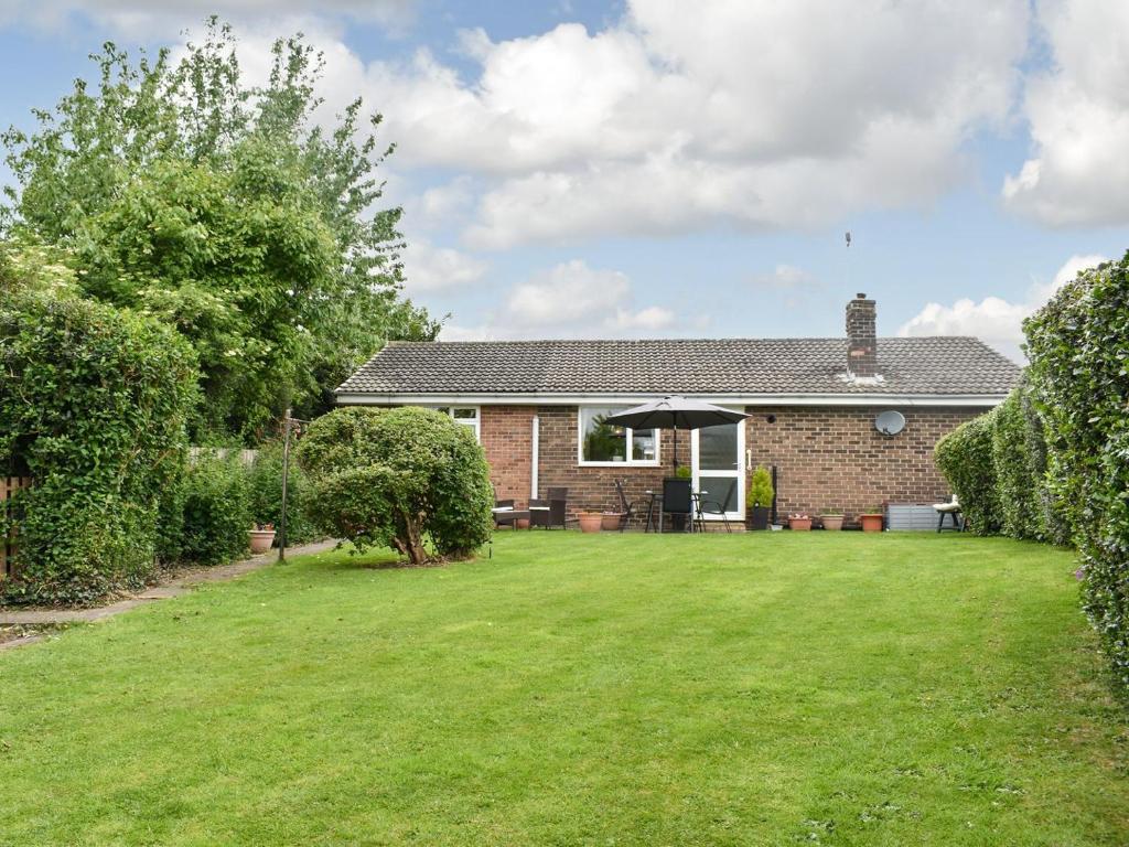 a brick house with a large lawn in front of it at Haweswater Cottage in Coundon