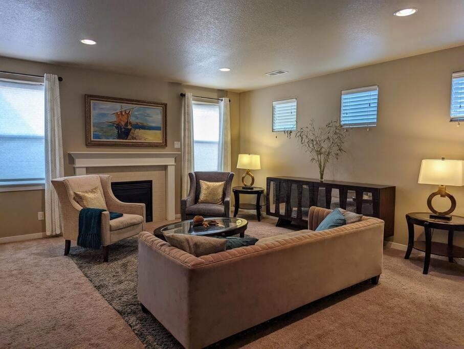 a living room with a couch and chairs and a fireplace at Spacious 3-bedroom home with outdoor space in Eugene