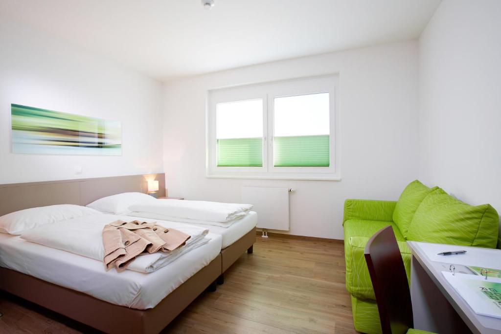 Postel nebo postele na pokoji v ubytování Good Rooms GmbH Guntramsdorf