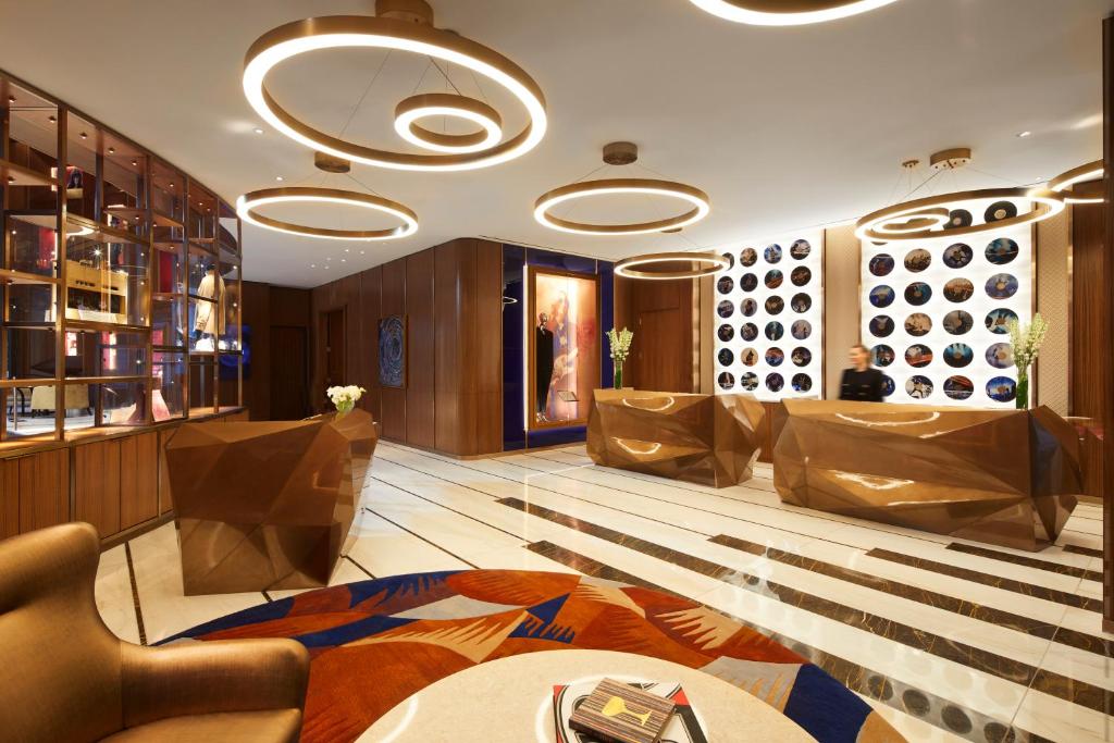 a lobby with chairs and a table in a room at Hard Rock Hotel New York in New York