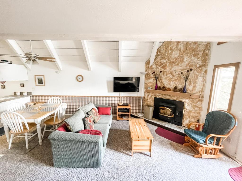 a living room with a table and a fireplace at Perfect Ski Rental 2 blocks from Village Gondola in Mammoth Lakes