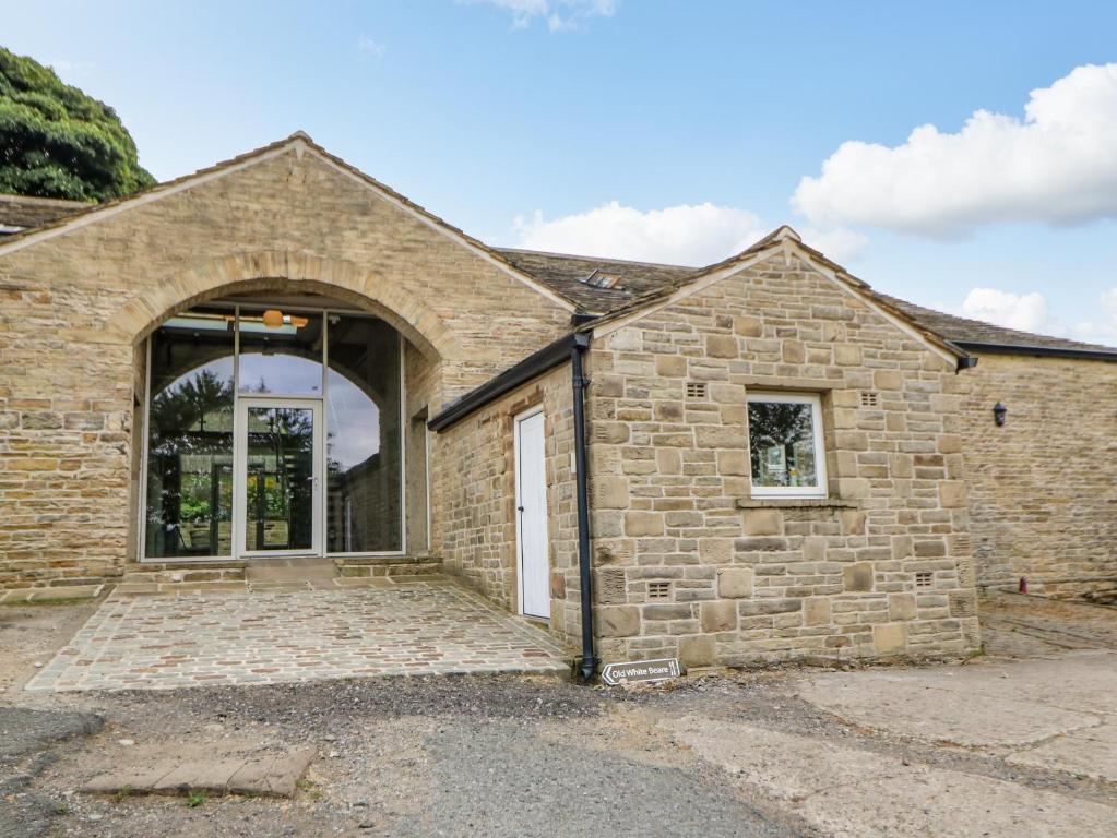 a stone house with a large glass door at 3 Barn Cottages in Halifax