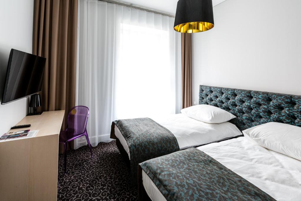 Posteľ alebo postele v izbe v ubytovaní Sleep in Hostel & Apartments Stary Rynek