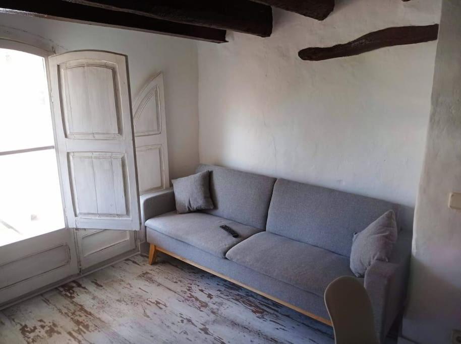 a living room with a couch and a window at casa costa dorada con piscina in Creixell