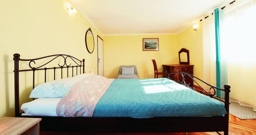 a bedroom with a bed with a blue comforter at Adriana Nova Vas in Nova Vas