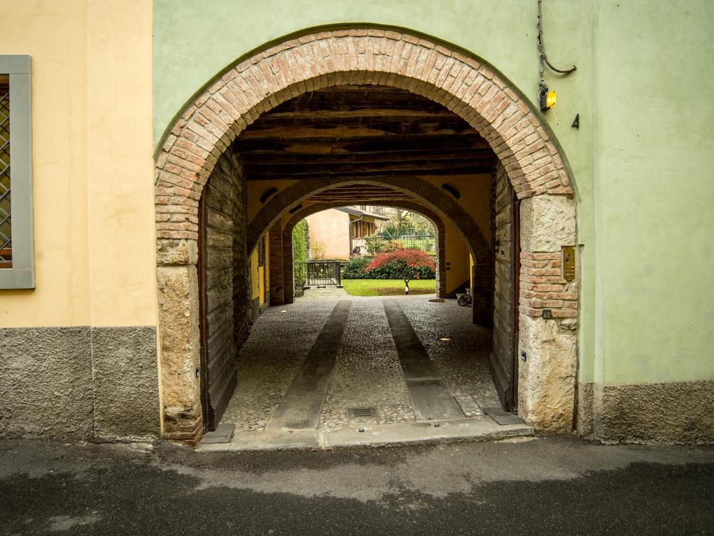 einen Torbogen in einem Gebäude mit Garten im Hintergrund in der Unterkunft B&B del Gran Ducato di Alzano Sopra in Alzano Lombardo