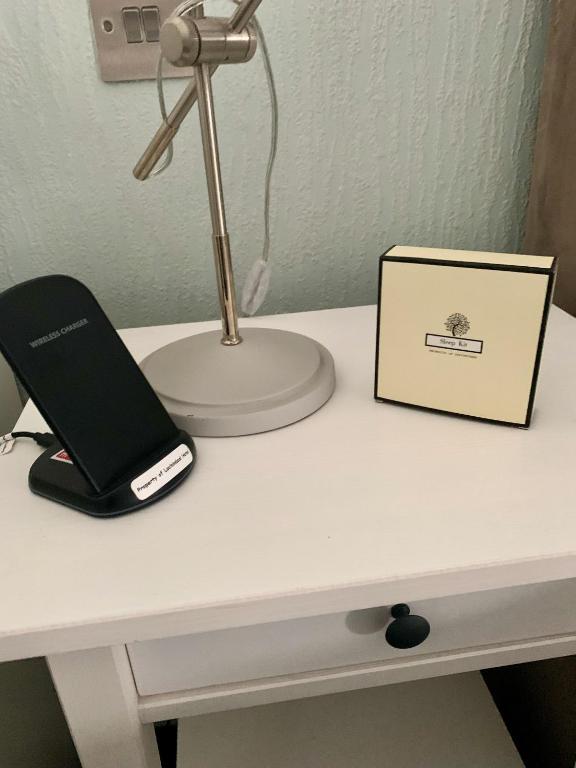 a desk with a laptop computer and a lamp on it at Lochindaal Hotel in Port Charlotte