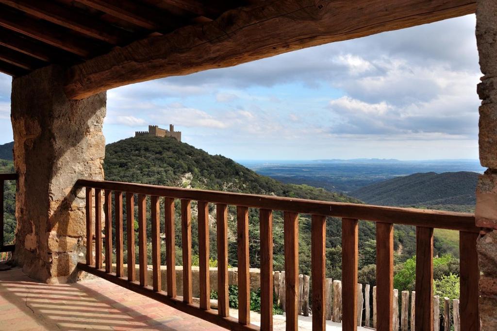 a balcony with a view of a castle on a hill at Requesens in La Jonquera