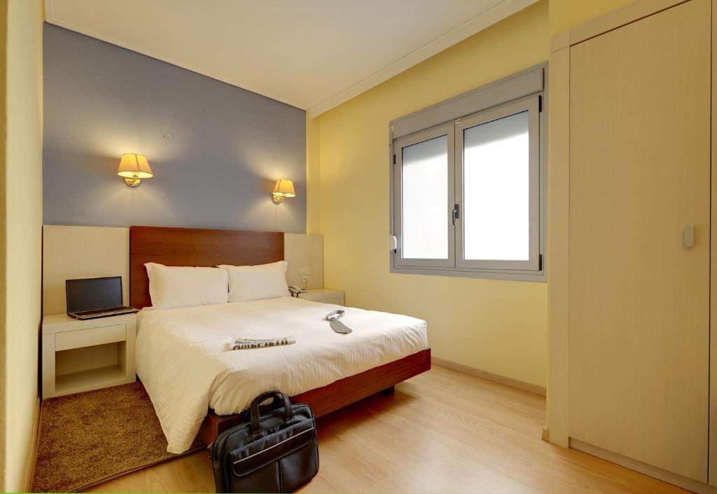 Postel nebo postele na pokoji v ubytování Esperia Hotel