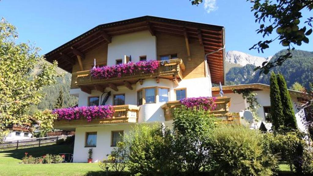 a building with flowers on the balcony of it at Haus Fuetsch in Virgen